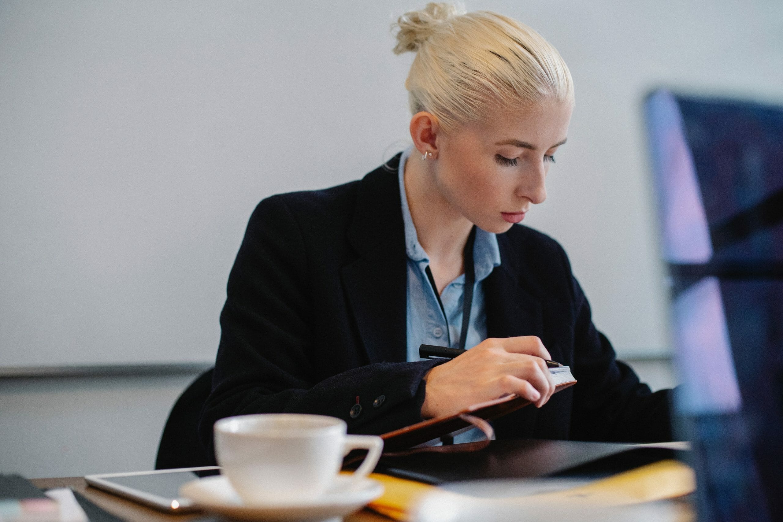 A woman reviews a report at her desk