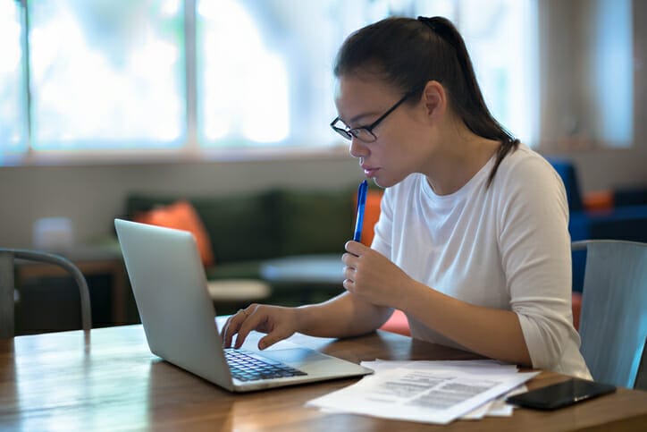 A young woman completes candidate testing on her laptop