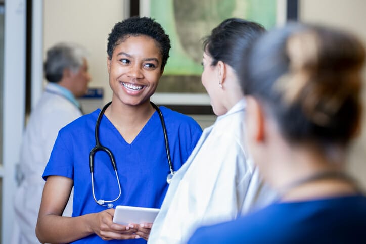 Company culture in healthcare. Nurses smile and laugh together.