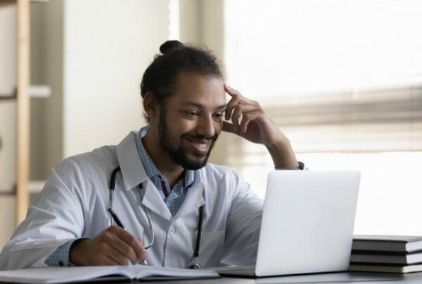A healthcare worker accesses the online part of his online onboarding
