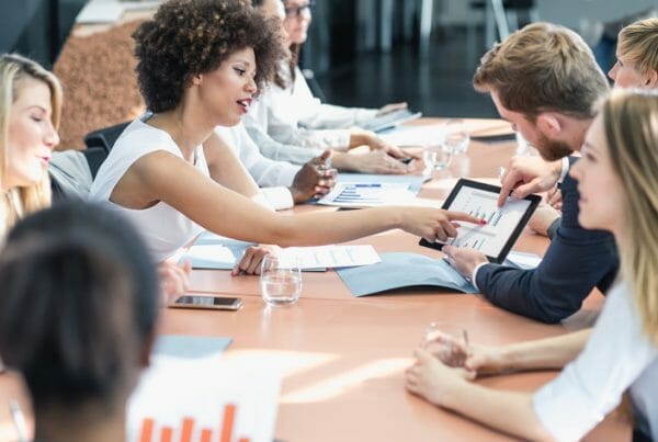 Operational insights. A group of business people work in a board room.