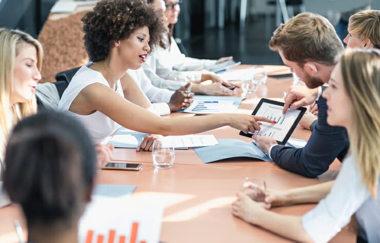 Operational insights. A group of business people work in a board room.
