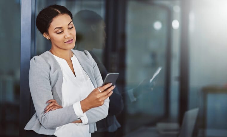 Facebook recruiting. A businesswoman looks at her smartphone.