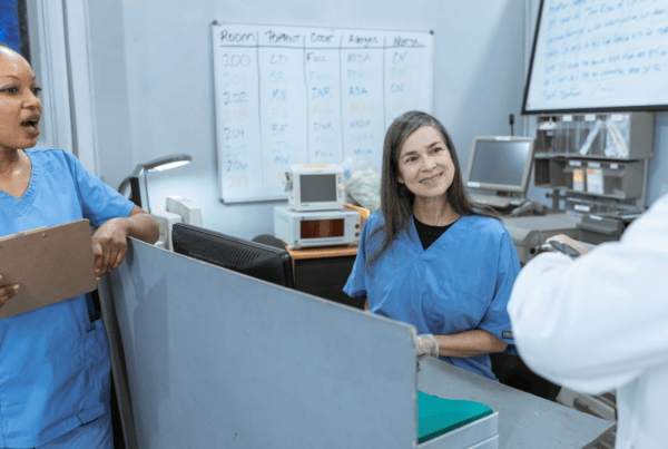 two nurses discuss compliance with a doctor after an effective training