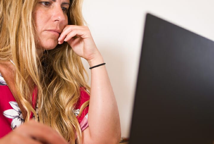 A woman on a computer considers using ChatGPT for hiring